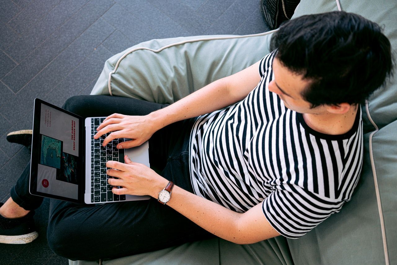 Photo of a person typing on a laptop